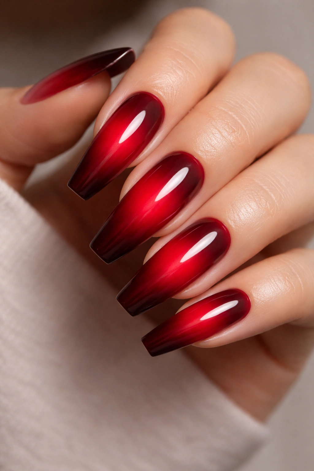 Close-up of coffin nails showing a ruby aura fade from center to edges