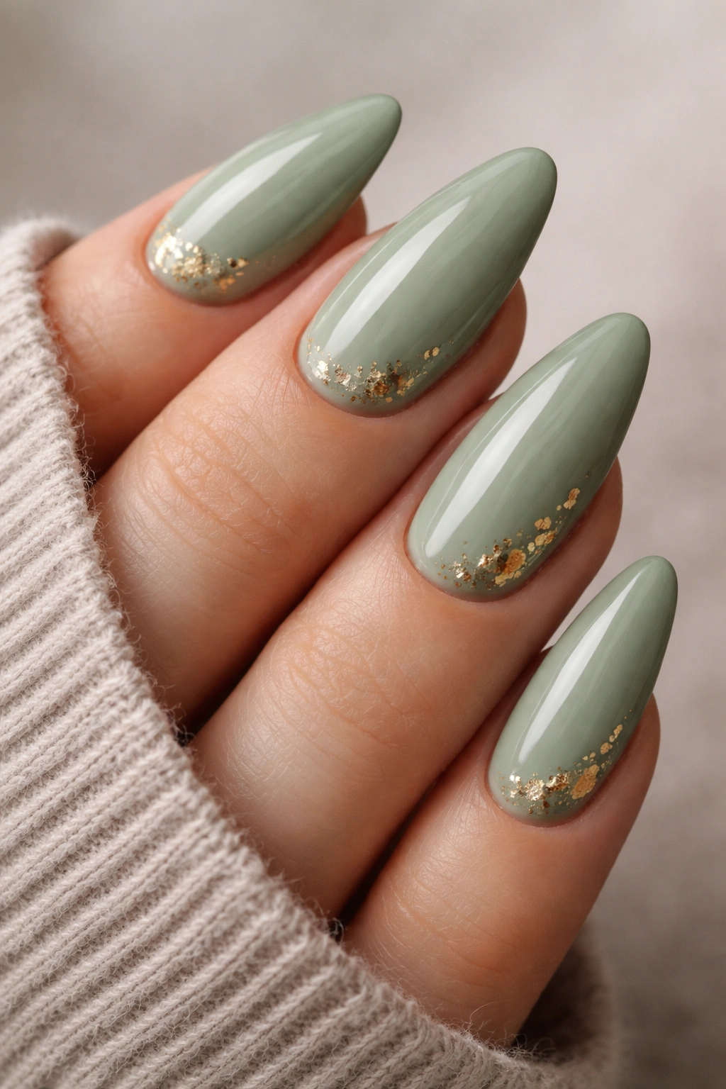 Sage green almond nails with micro gold foil accents