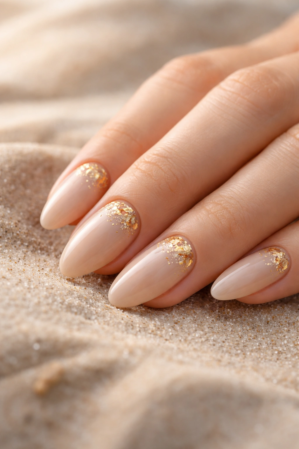 Beige nails with small irregular gold foil accents