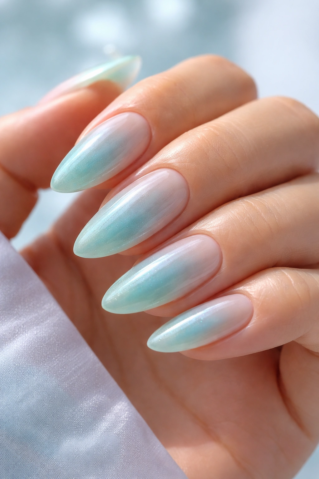 Almond nails with sea glass sheer featuring a translucent blue-green center over a milky base