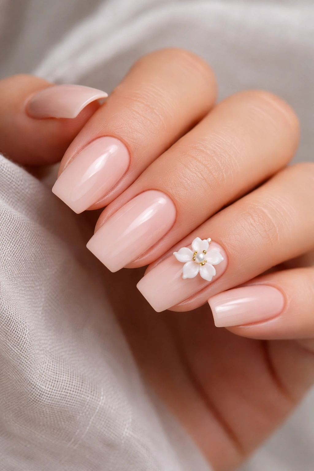 Close-up short coffin nails with one accent bloom on the ring finger.