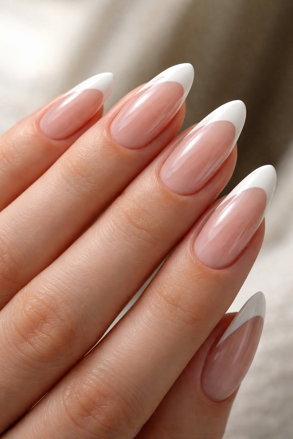 Almond nails with a side-swept diagonal white tip