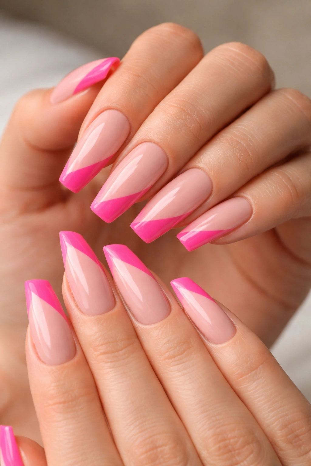Nails with side-swept diagonal pink tips on angled coffin nails