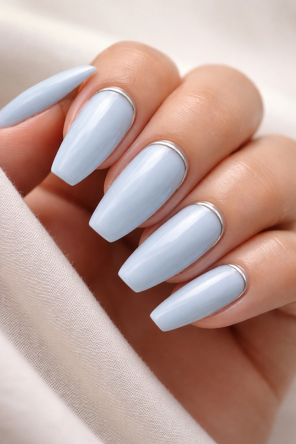 Blue nails with a thin silver cuticle line