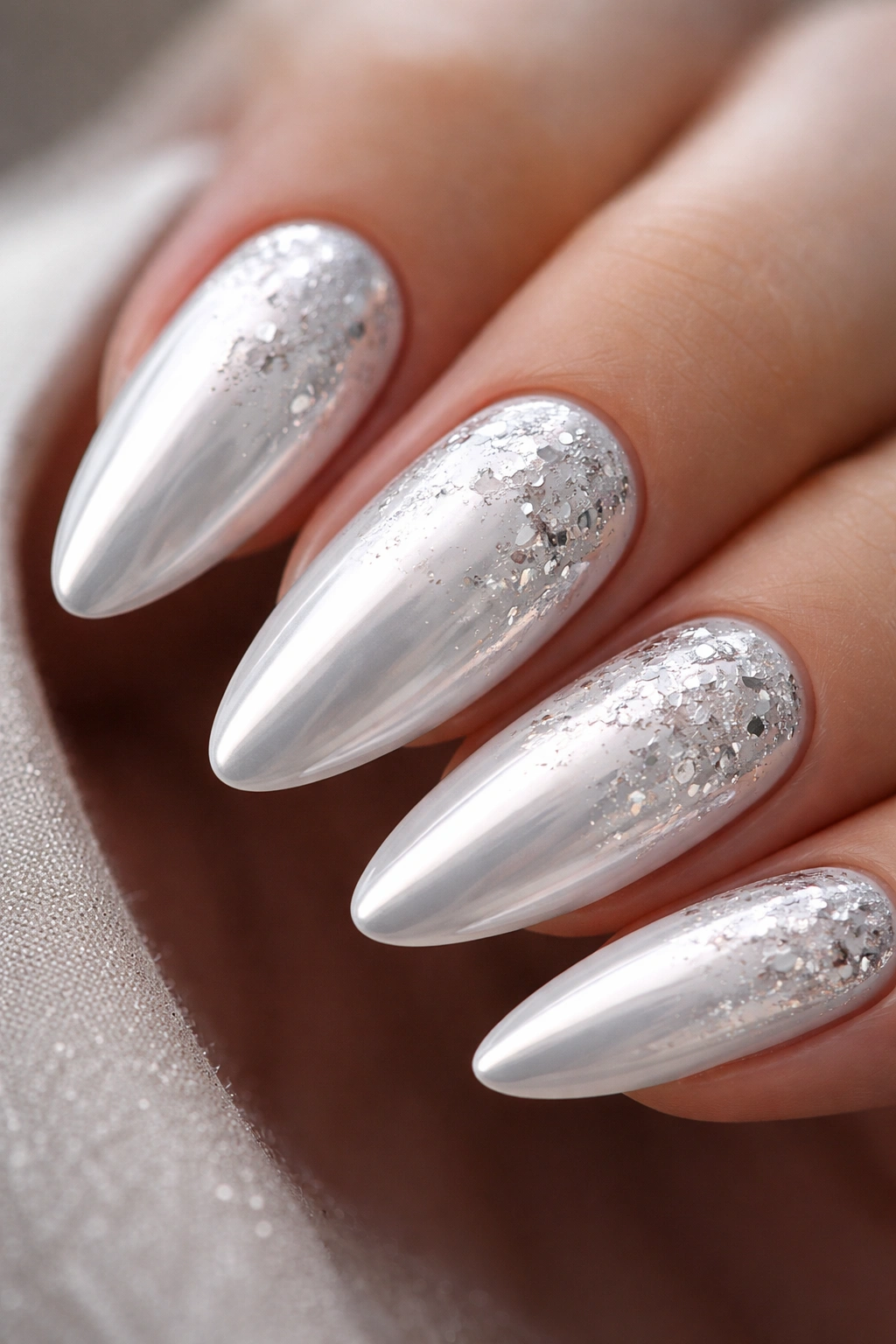 Almond nails with white chrome and silver foil flakes