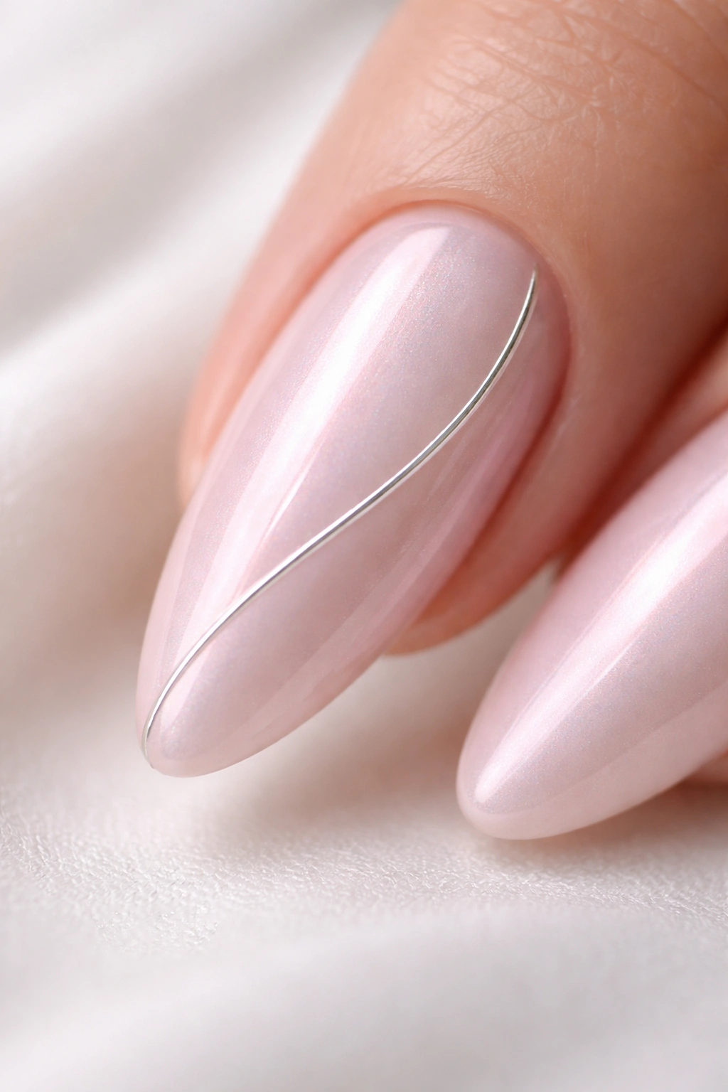 Almond nail with pink chrome base and a thin silver line along its curve