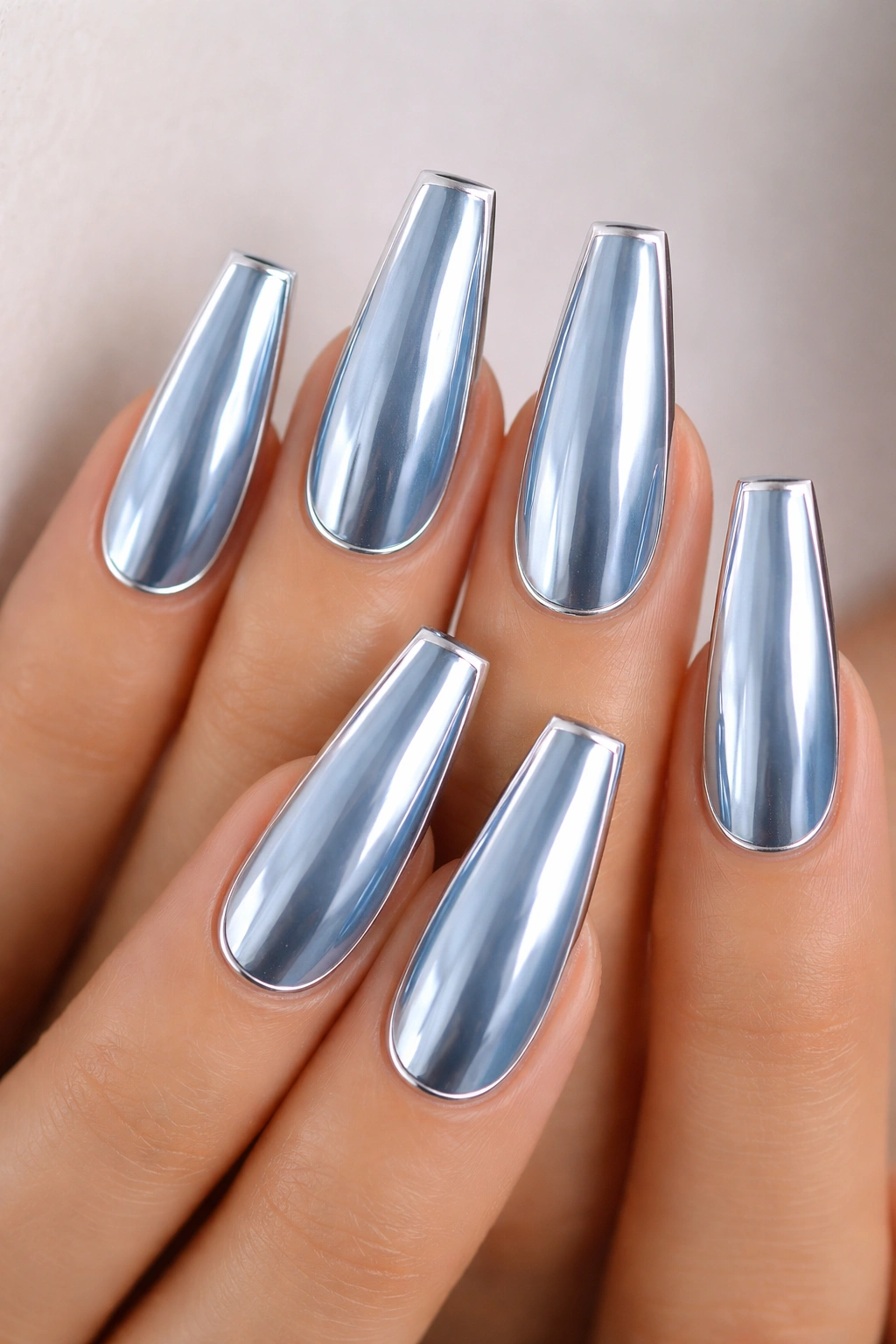 Close-up of Silver-Outlined Light Blue Chrome Coffin Nails with a thin silver border