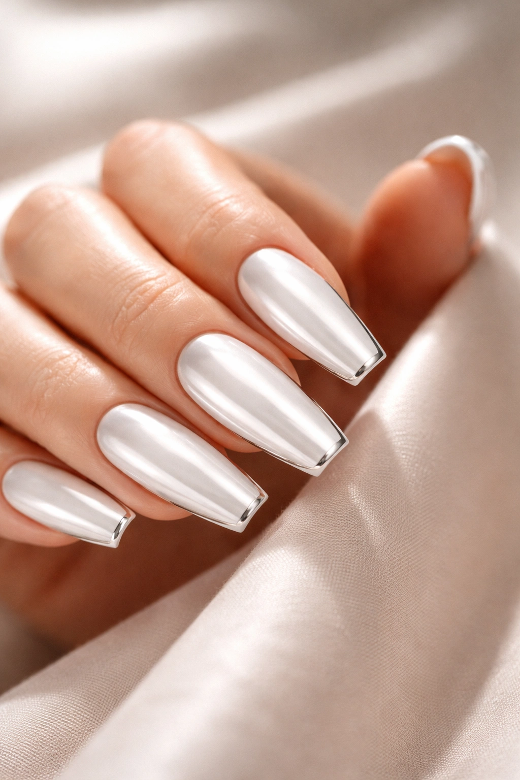 White chrome coffin nails with a slim silver outline