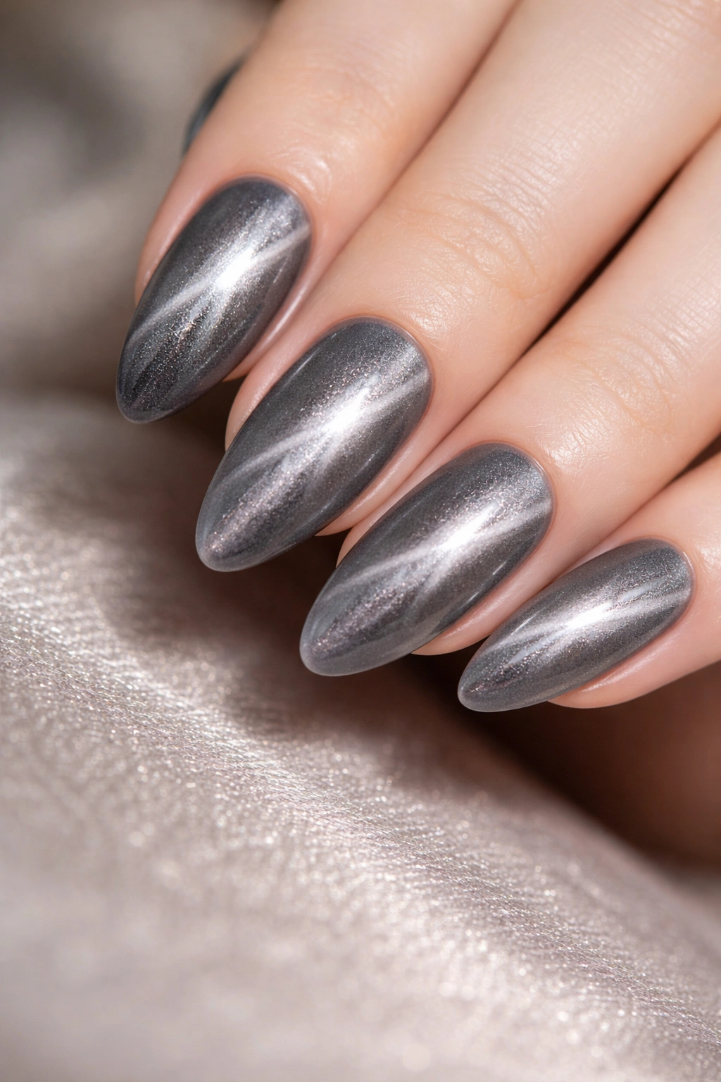 Silver smoke cat eye nails on almond nails with off-center silver line