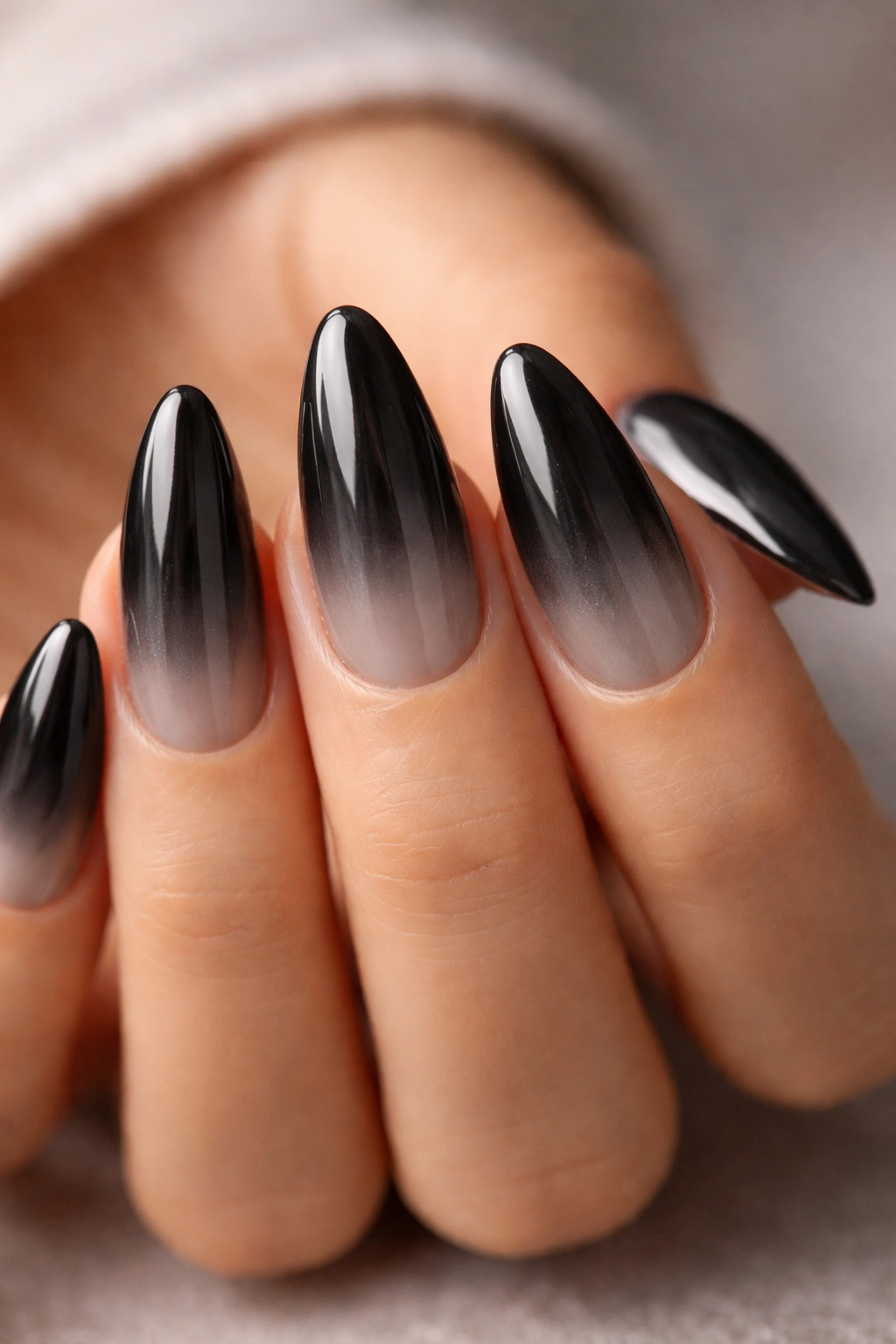 Smoky ombré black chrome on almond nails with bright tips