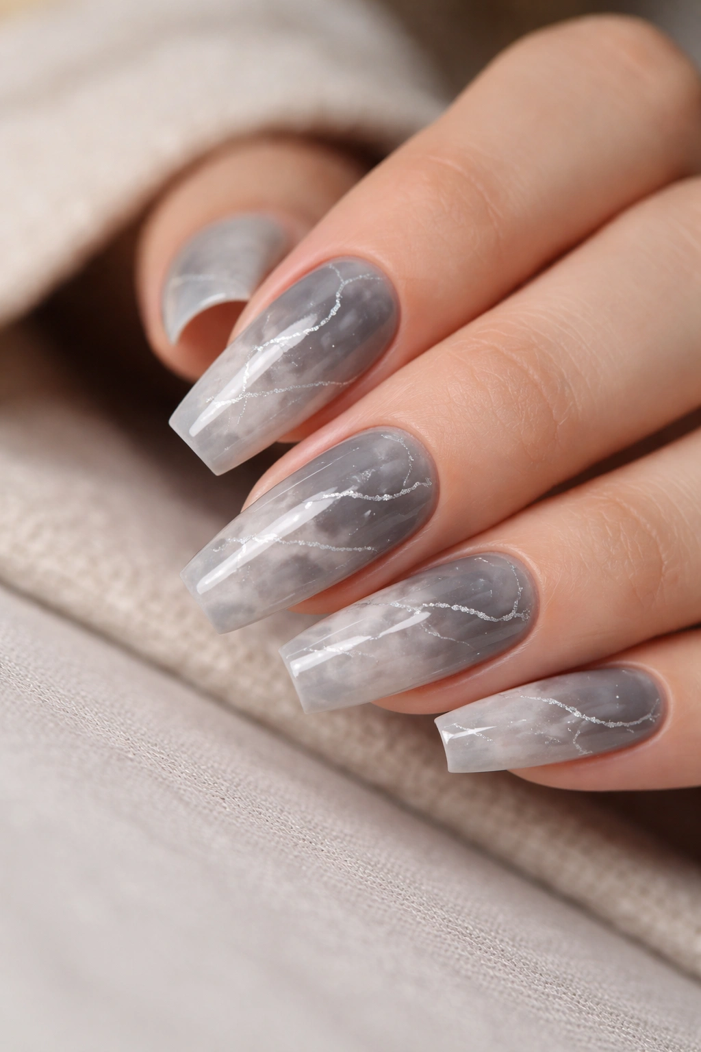 Close-up of smoky gray marble coffin nails with fine silver veins and glossy finish