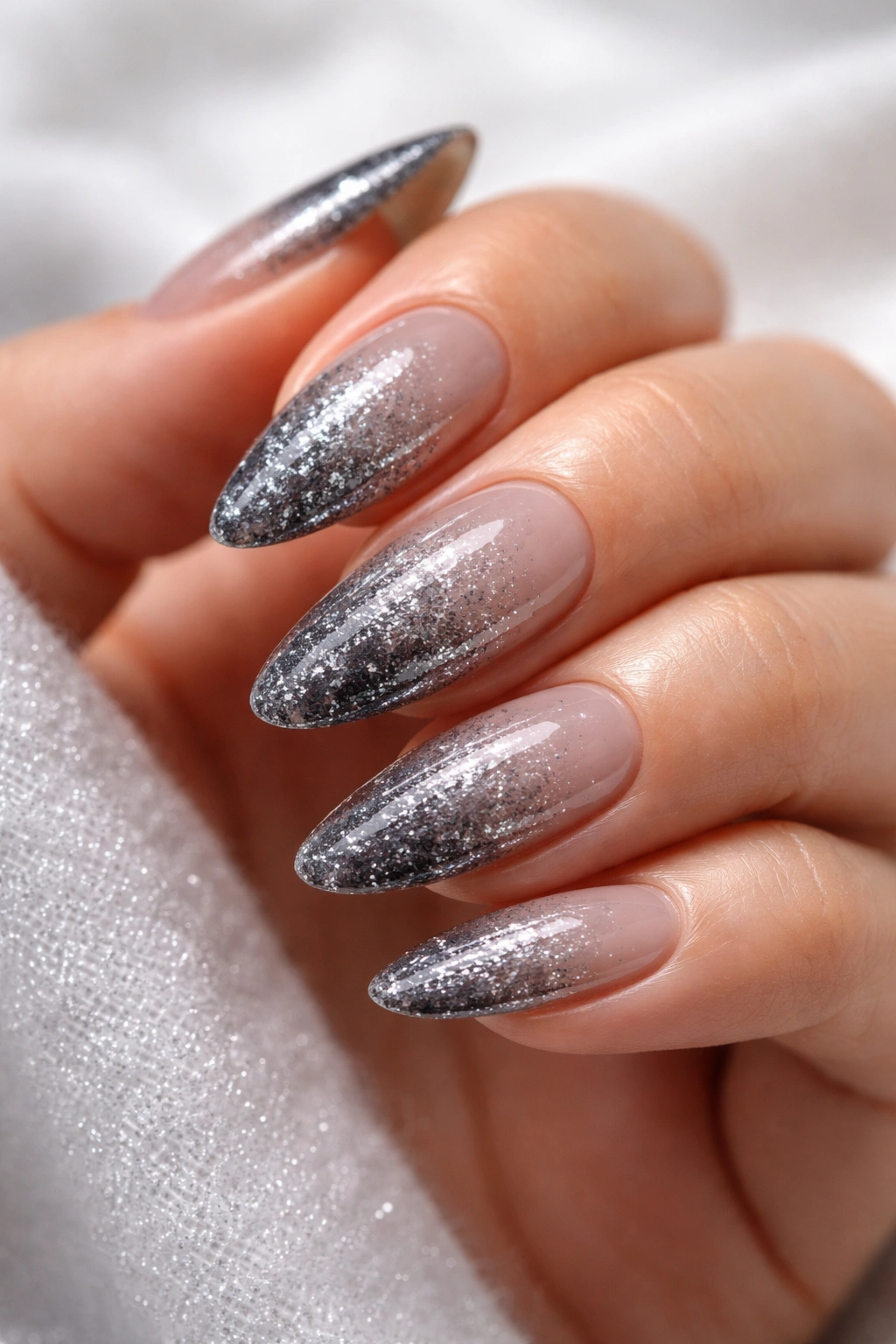 Almond nails with a smoky grey glitter gradient from base to tip.