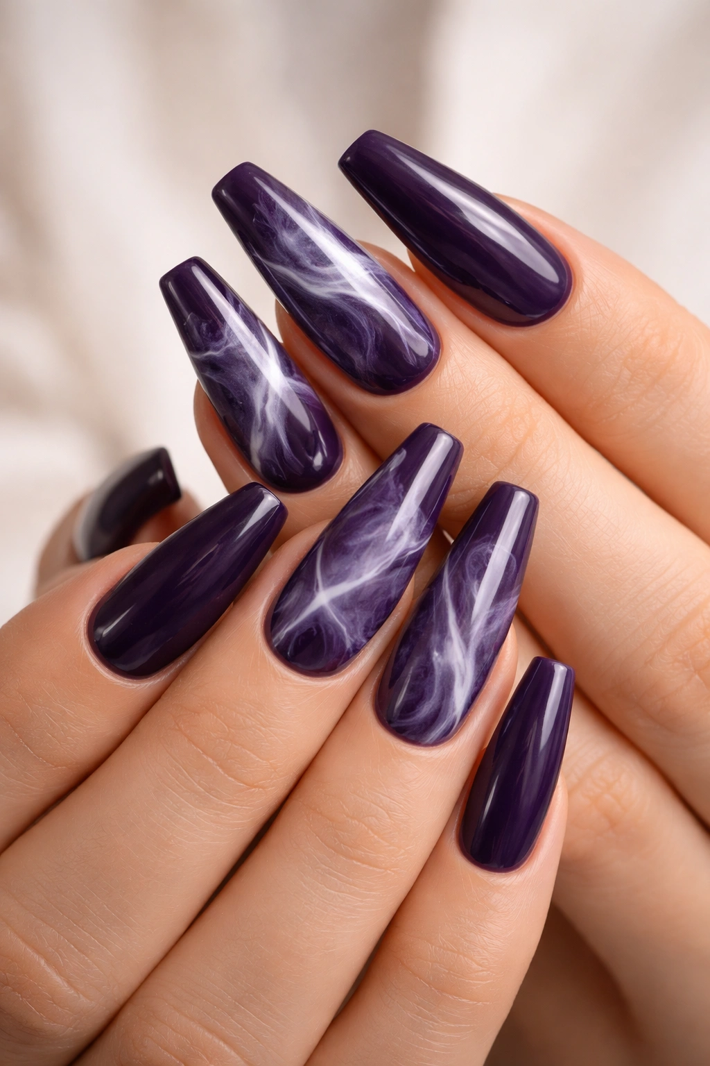 Smoky purple marble nails with milky white swirls on ballerina tips