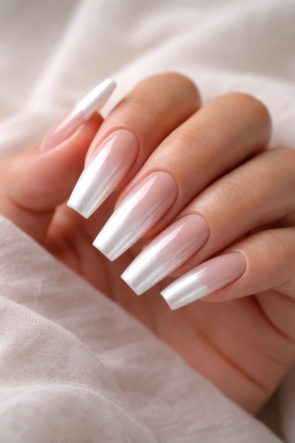 Nude to white ombre coffin nails with chrome sheen