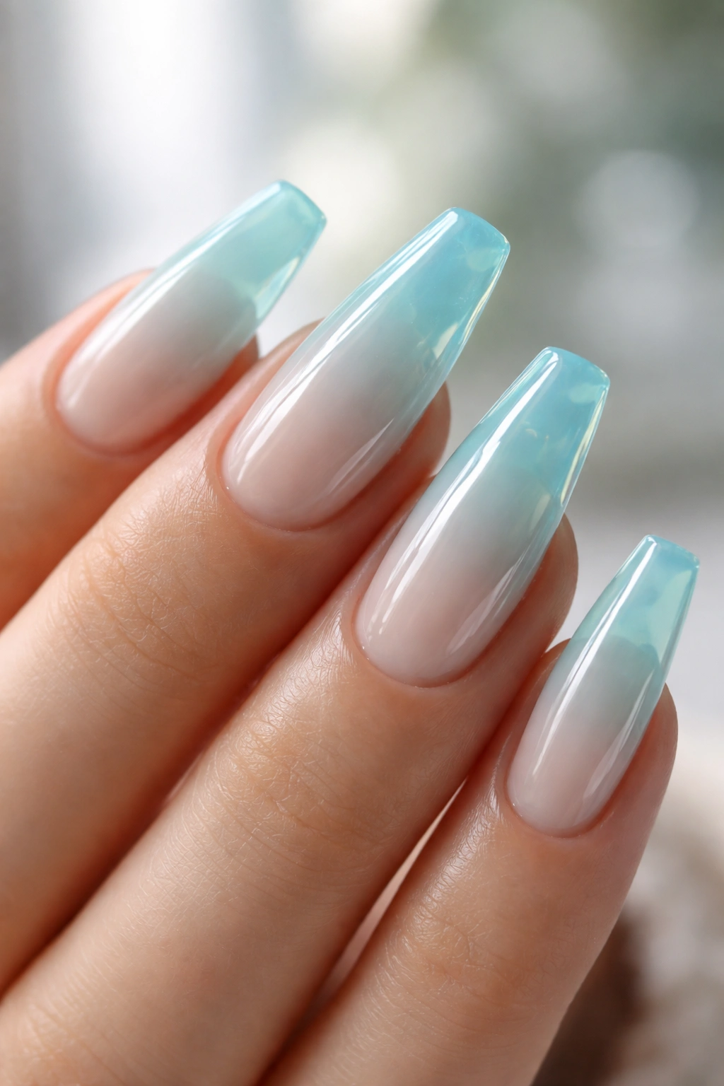 Soft aqua jelly coffin nails showing translucent blue-green layers