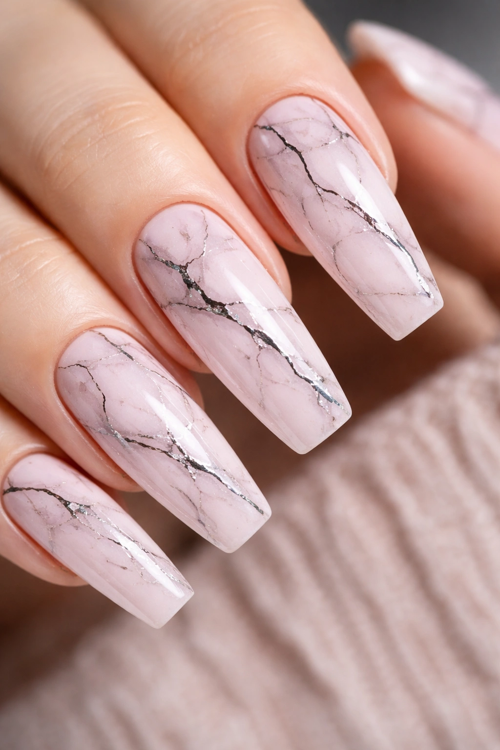 Soft pink marble coffin nails with delicate black ink veining