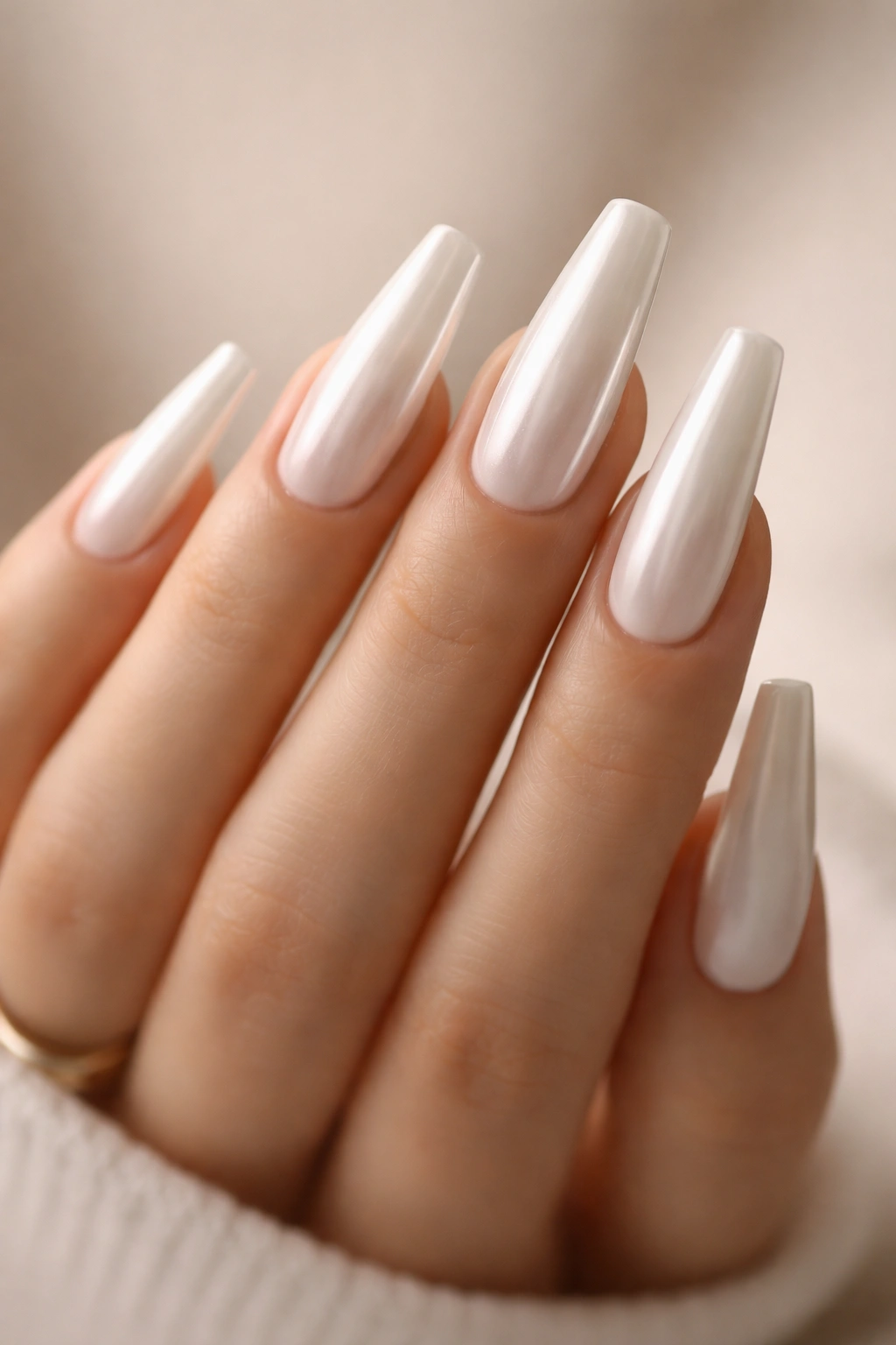 Soft white chrome coffin nails with pearly reflective finish on long coffin shape