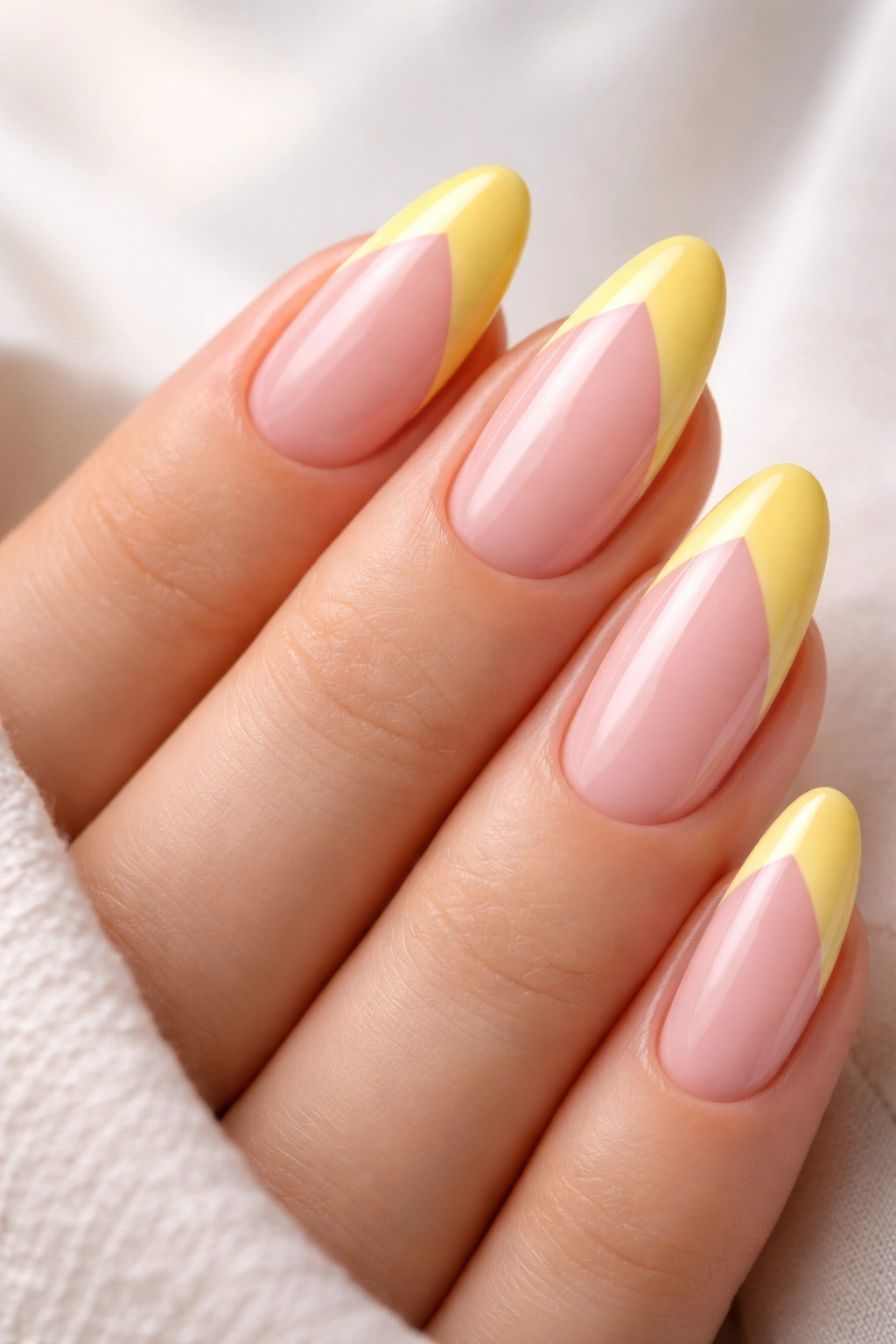 Split French almond nails with yellow tip and sheer pink opposite