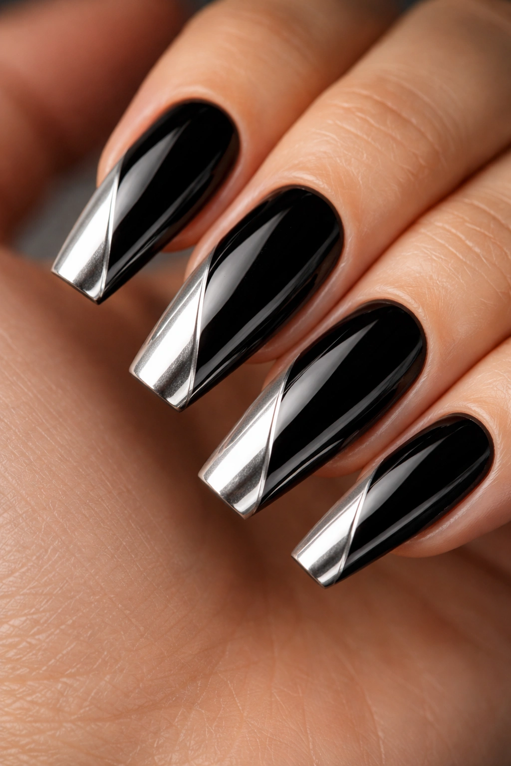 Close-up of coffin nails with diagonal black and silver split-tip chrome