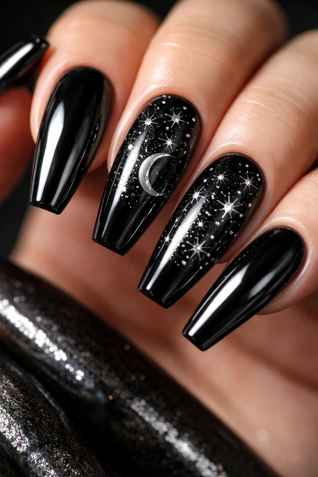 Close-up of two accent nails with star map over black chrome