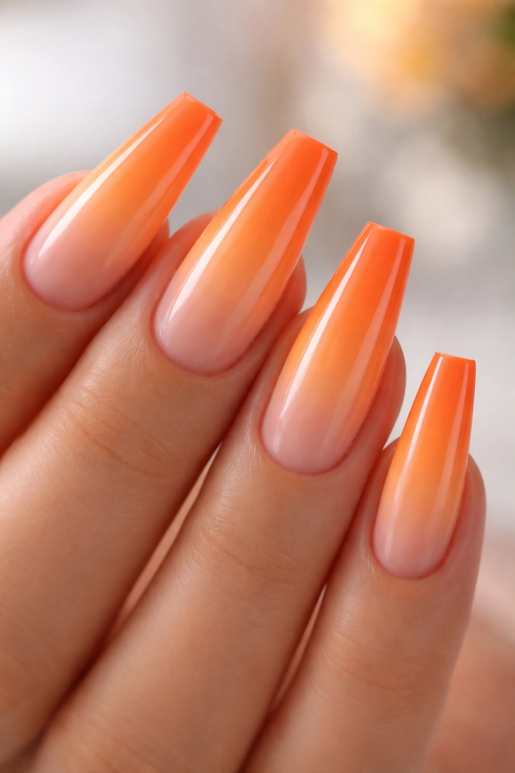 Ombré orange coffin nails with sunset gradient and glossy finish