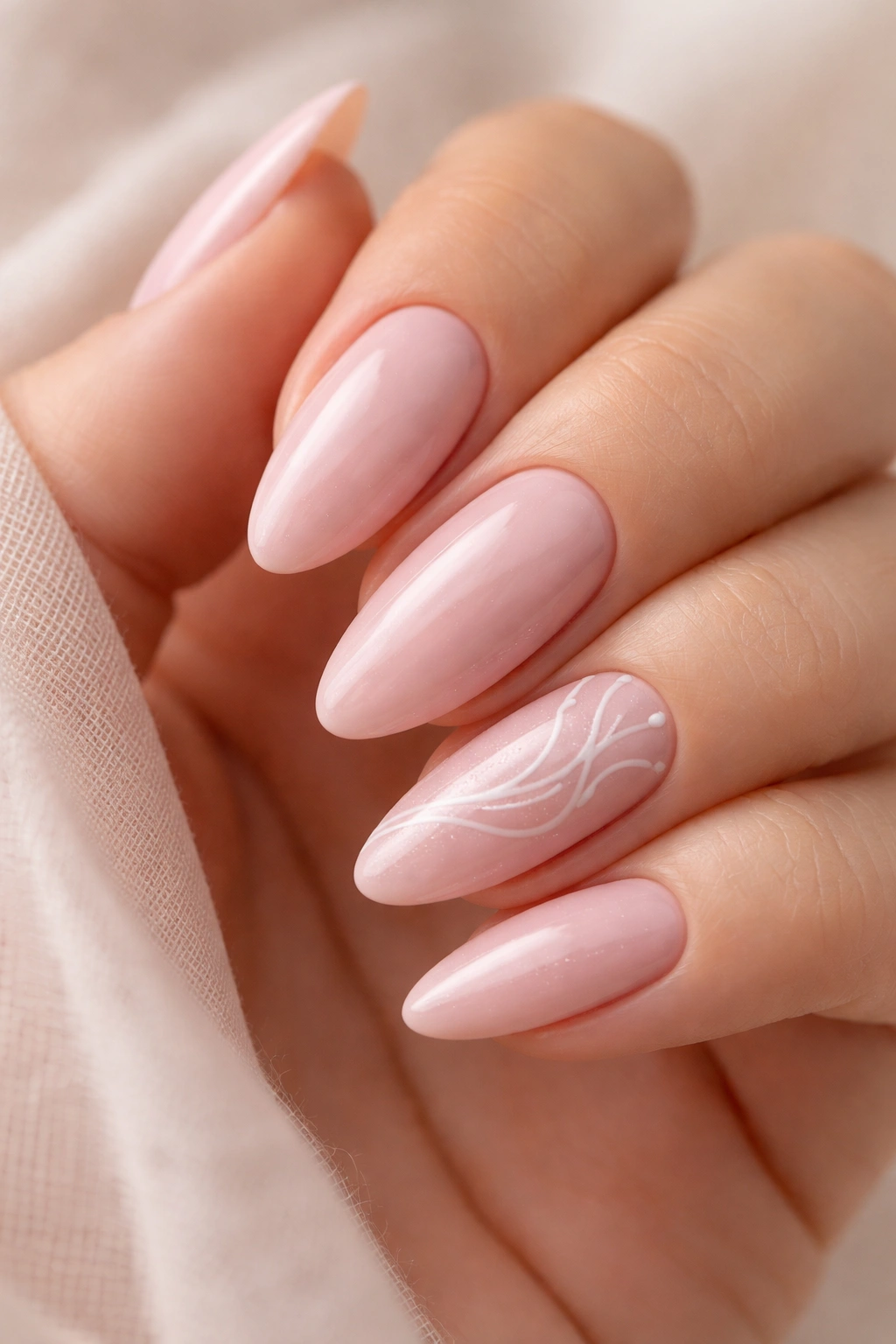 Almond nails with white swirl lines on blush pink base (accent nail)