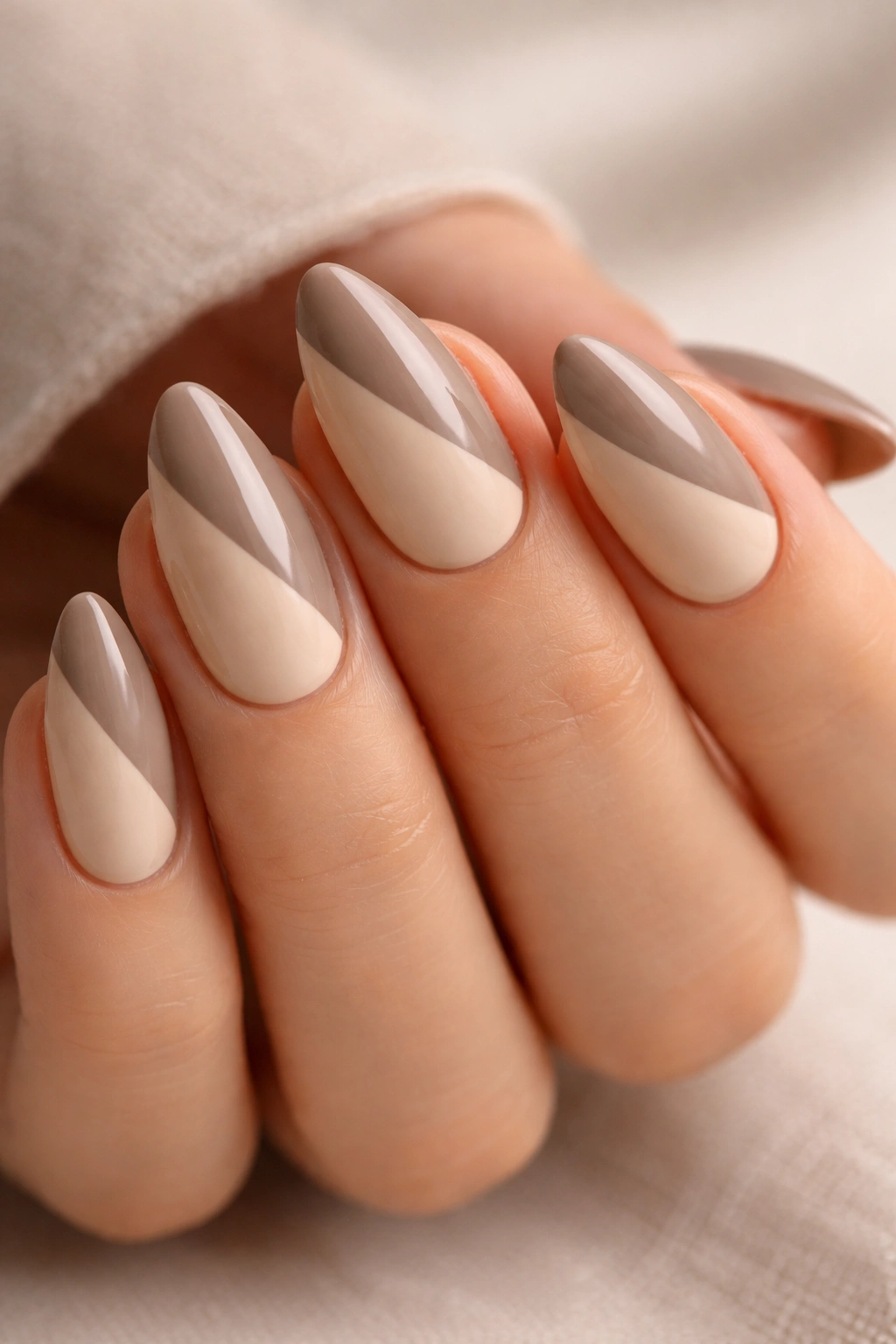 Beige and taupe color-block almond nails with diagonal split