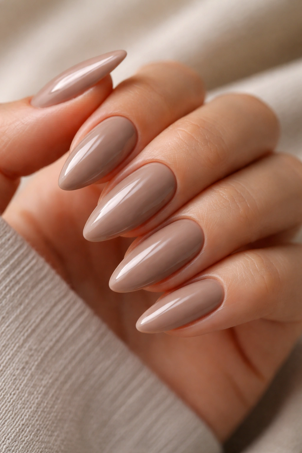 Taupe nude almond nails with glossy finish