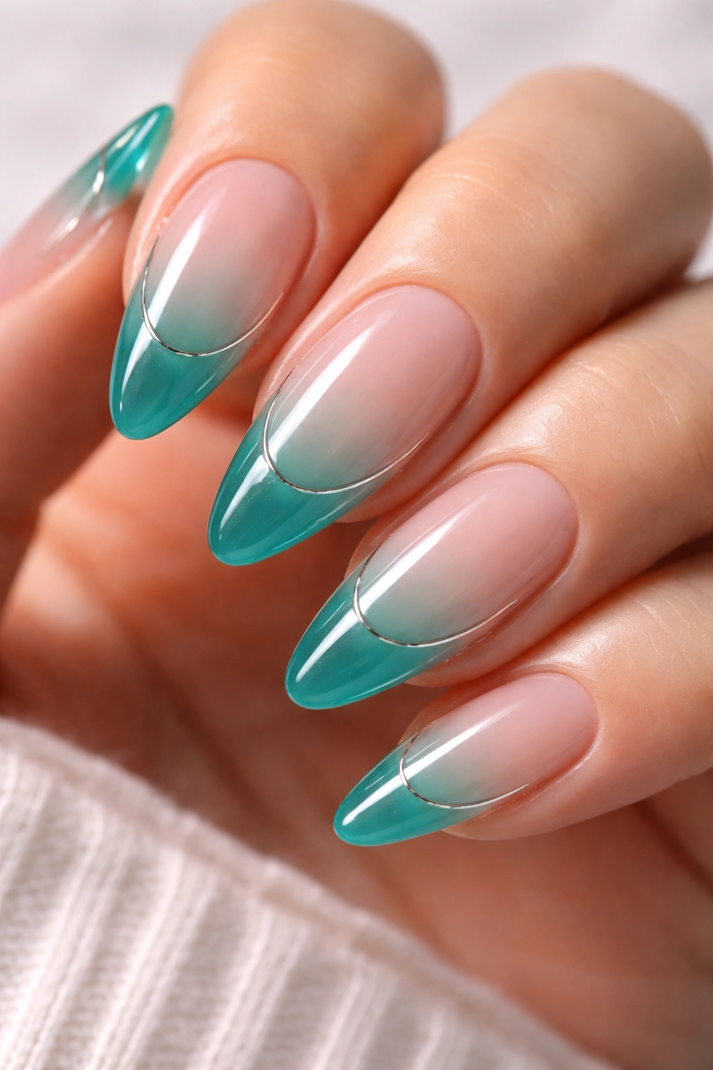 Almond nails with teal jelly tips over nude base, Y2K French style.