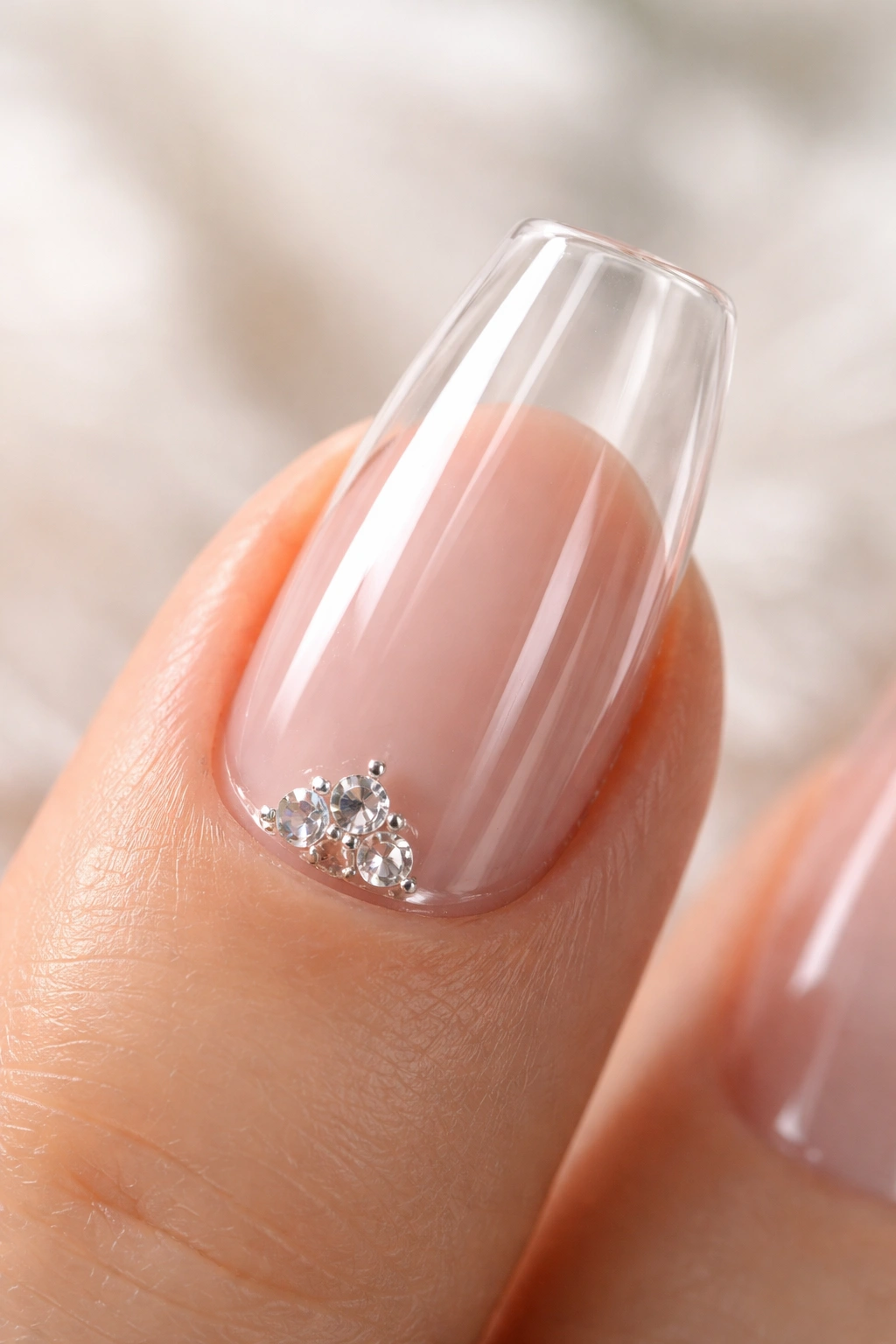 Close-up of a coffin nail with a small crystal cluster near the cuticle on clear base