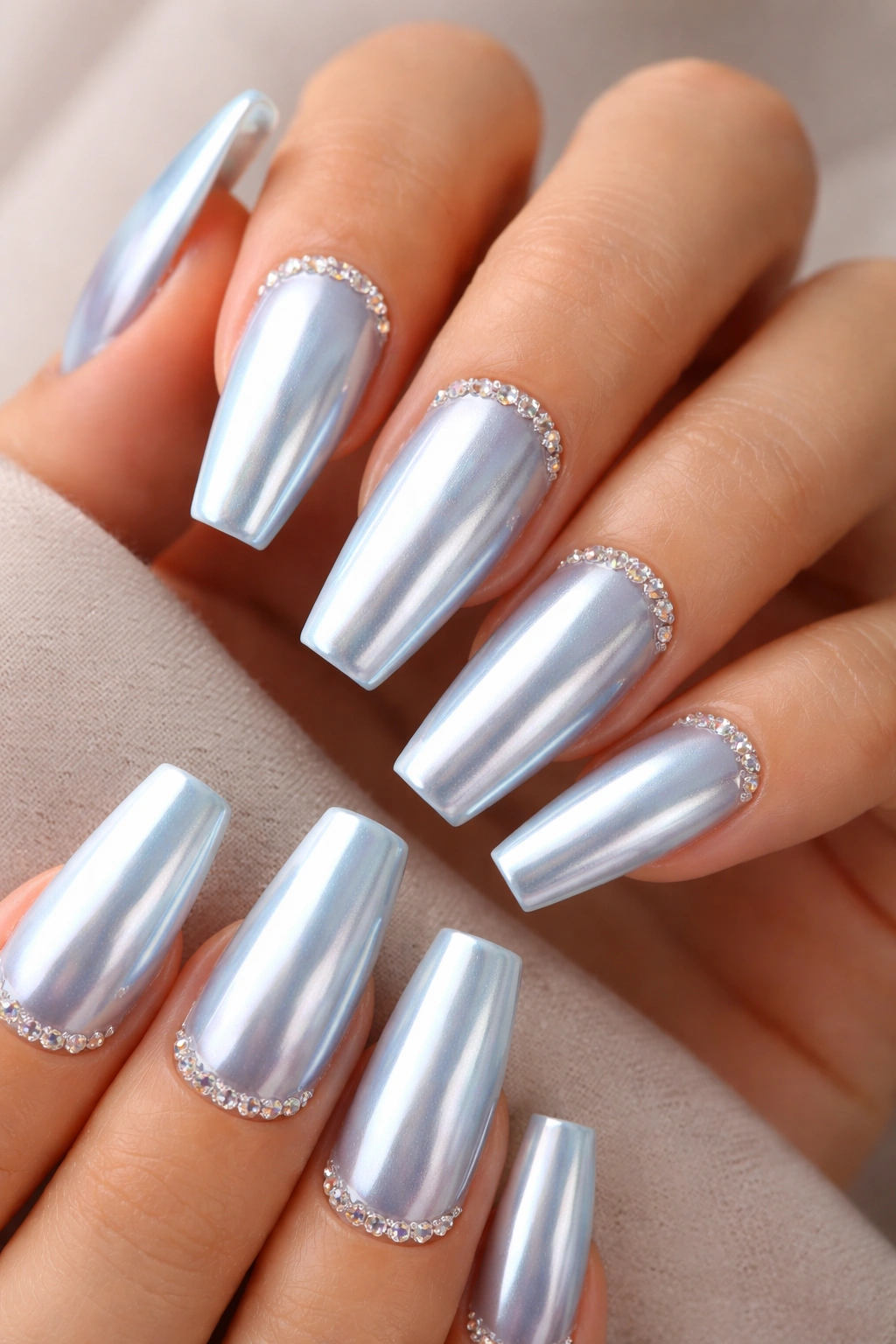 Light blue chrome coffin nails with tiny crystals near the cuticles
