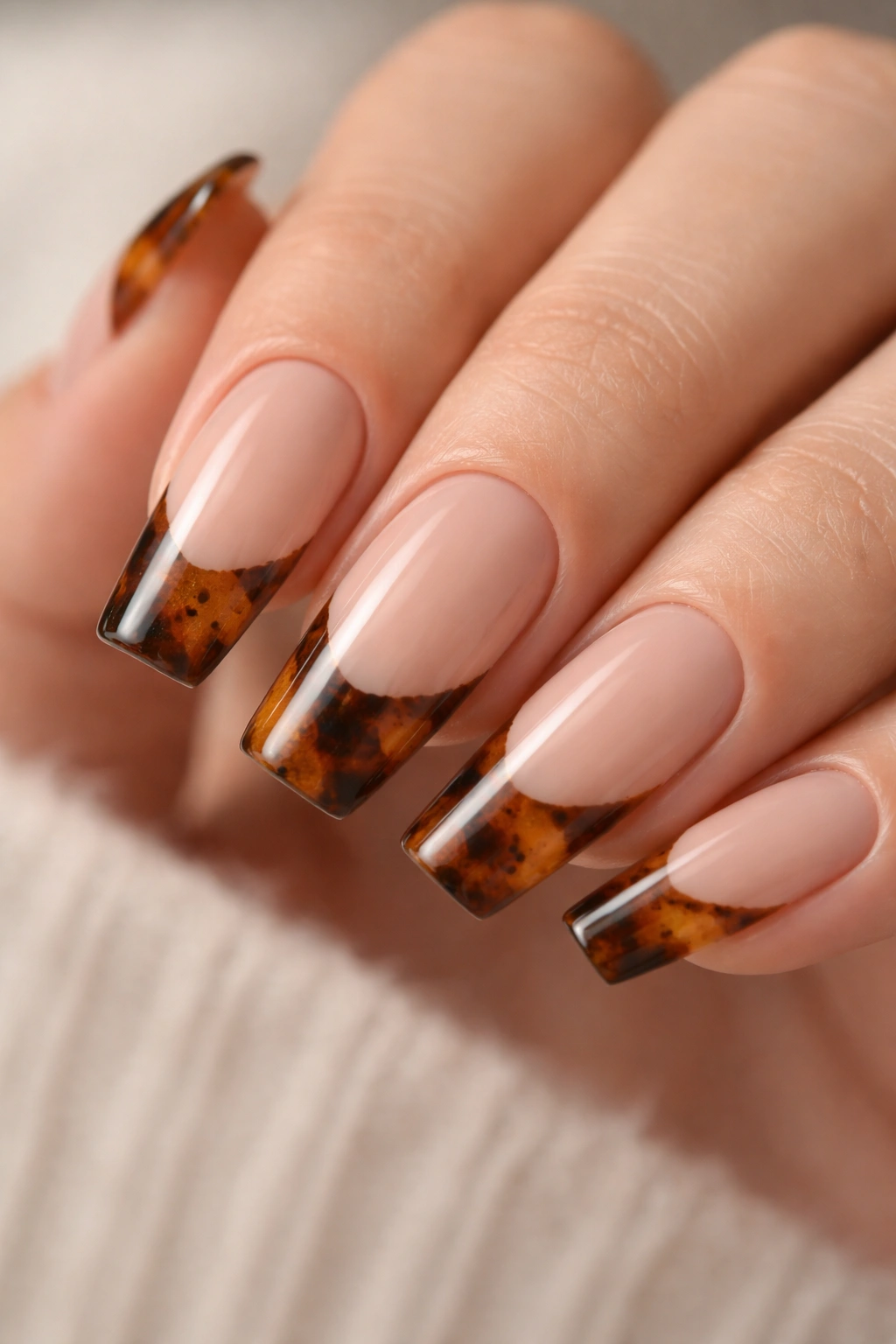 Medium coffin nails with tortoiseshell tips over a sheer nude base