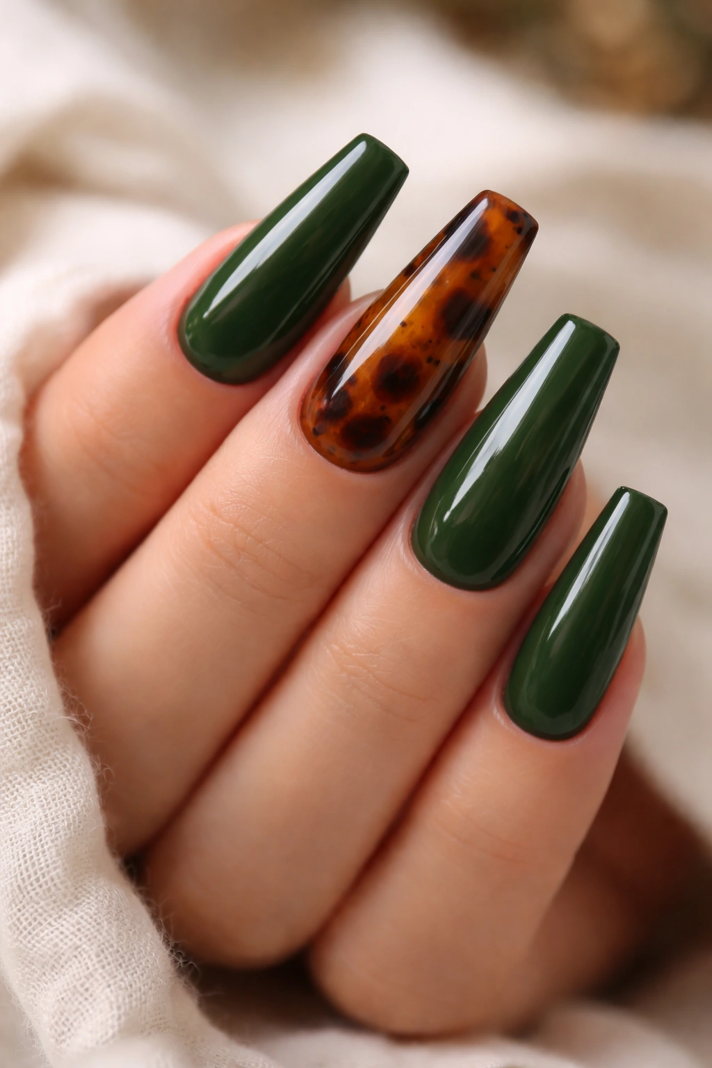 Tortoiseshell accent nails on moss green coffin nails with glossy finish