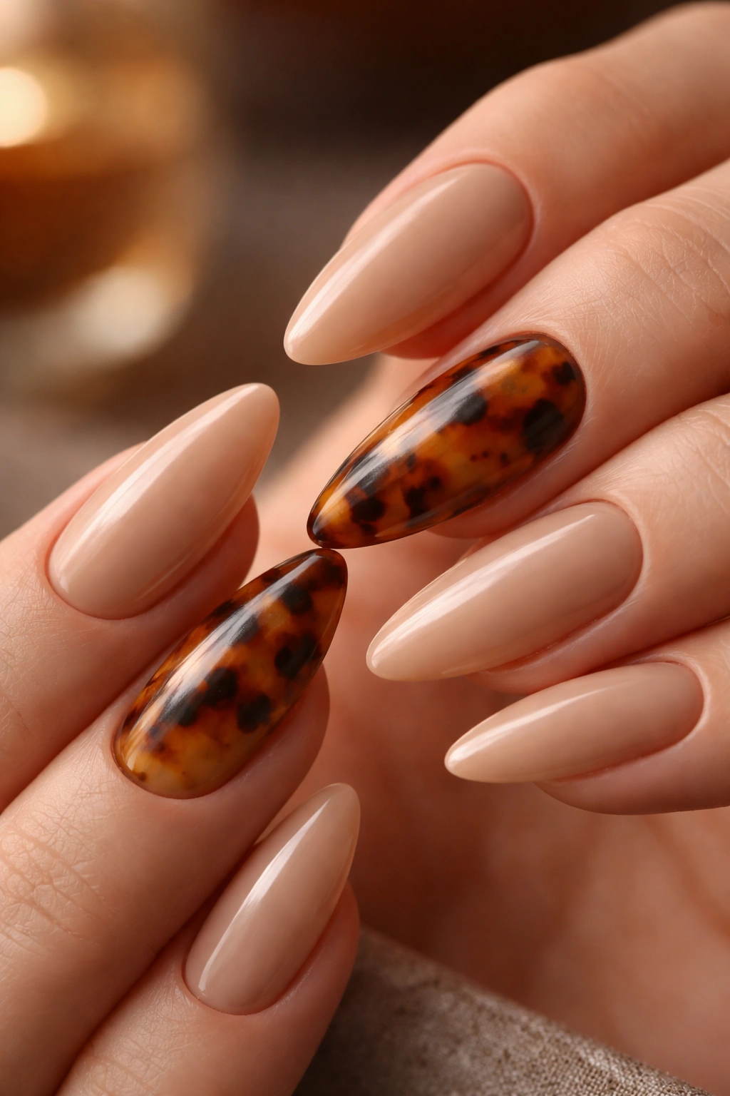 Almond nails with tortoiseshell accent on nude base