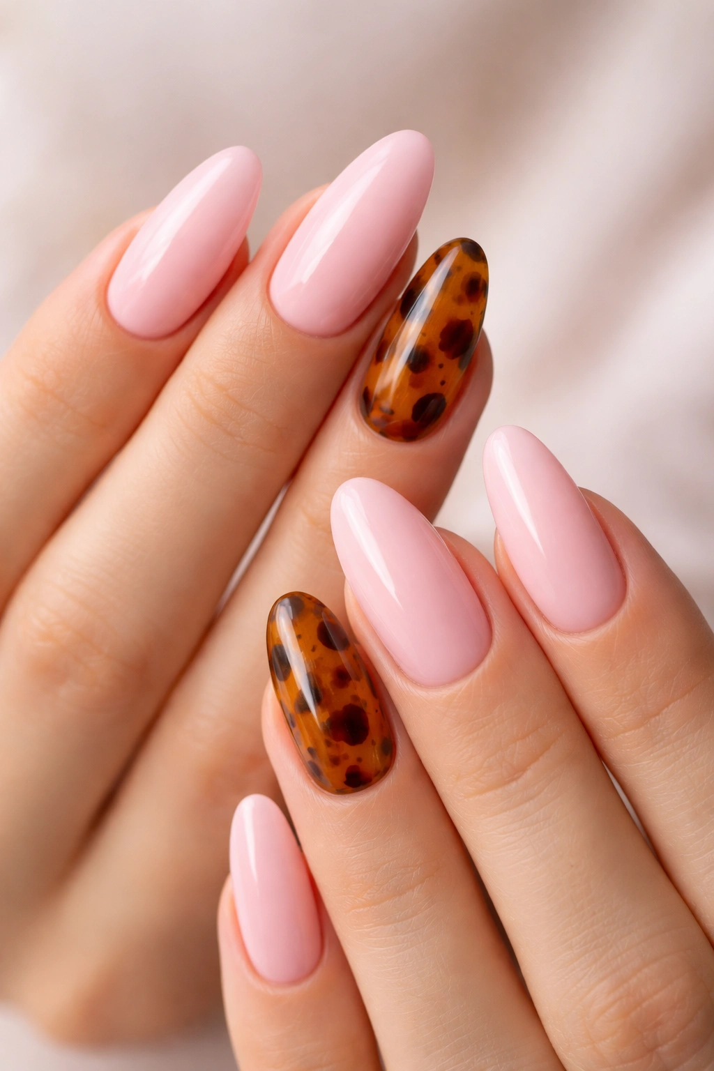 Close-up of tortoiseshell accent nails on almond nails