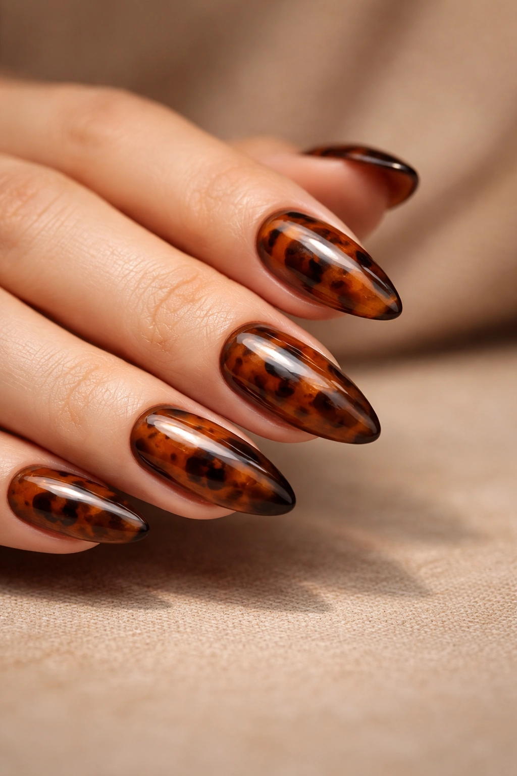Almond nails with tortoiseshell pattern in amber and brown tones