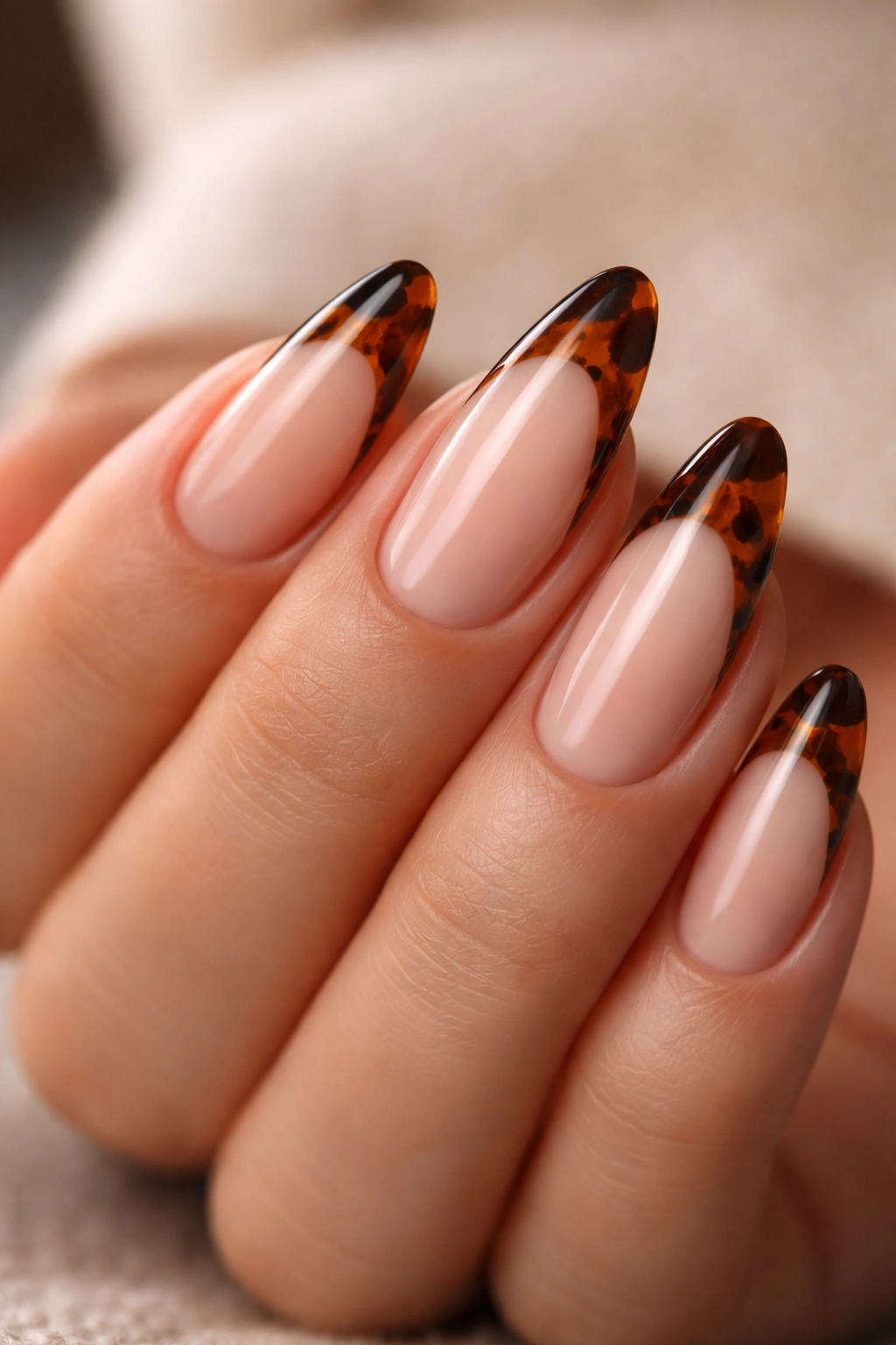 Almond nails with tortoiseshell tips on a nude base