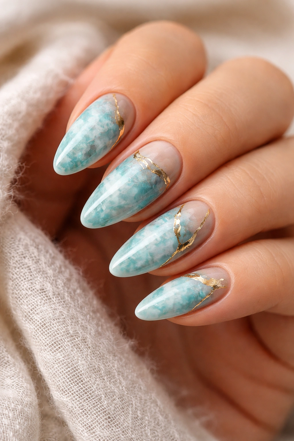 Close-up of turquoise stone nails with gold veining