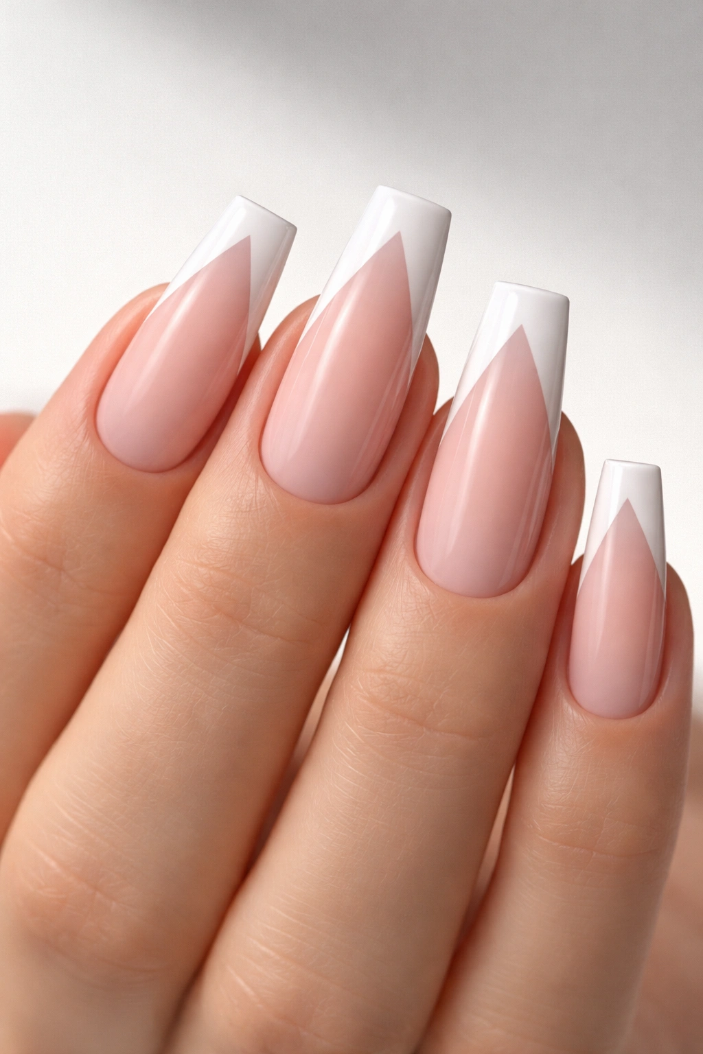 Close-up of V-cut French tips that stretch coffin shape