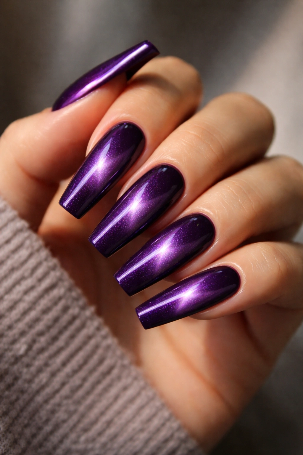 Close-up of velvet cat-eye purple coffin nails showing magnetic shimmer