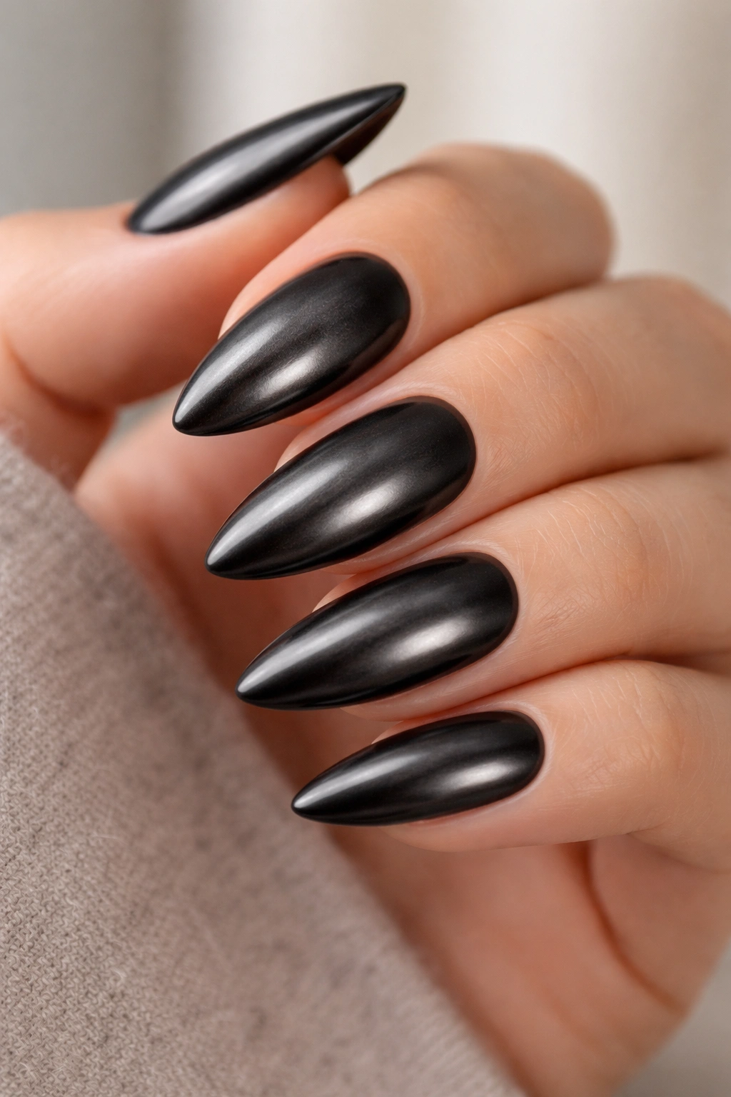 Almond nails in velvet black chrome with soft brushed shine