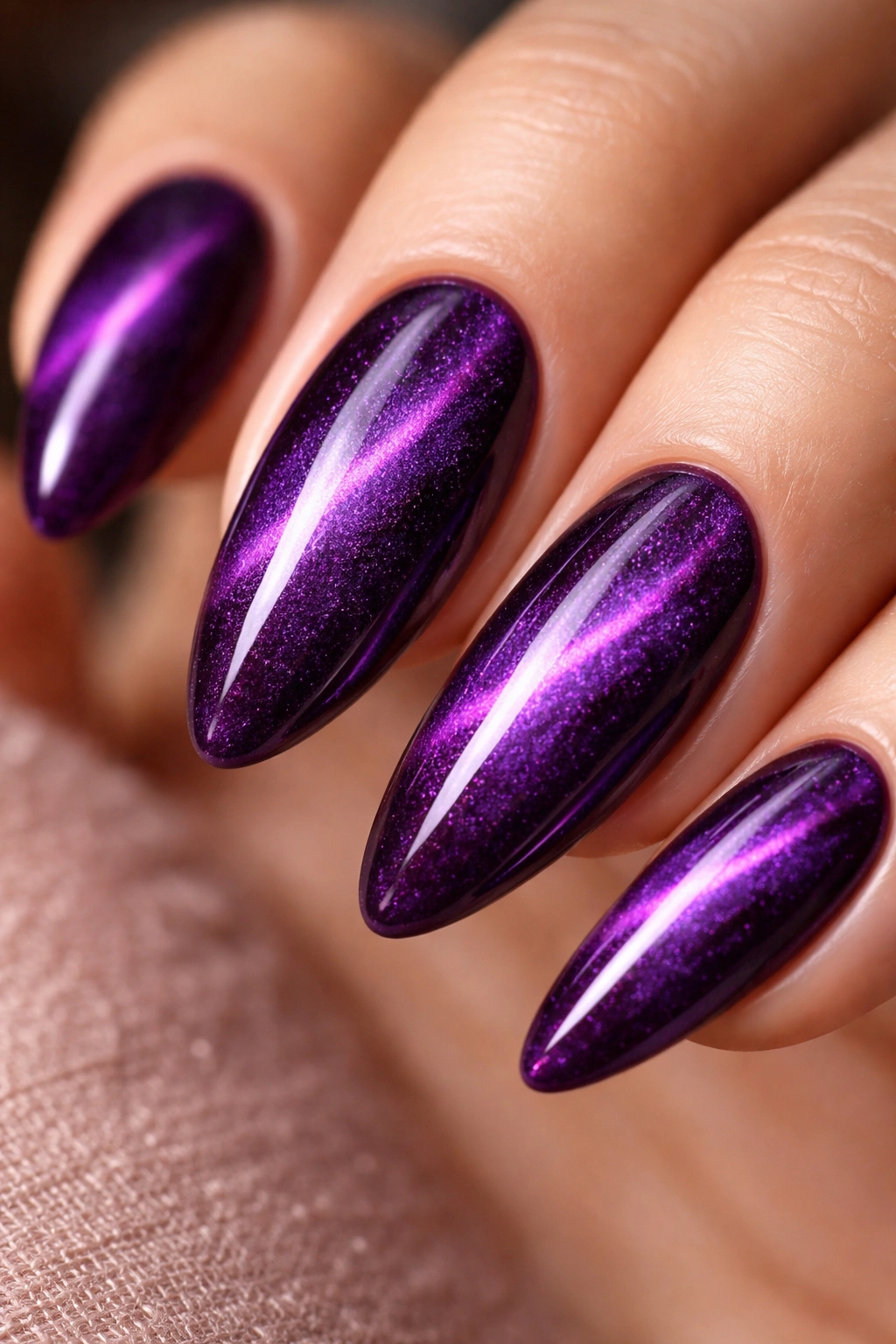 Almond nail with velvet purple magnetic depth and broad shimmer