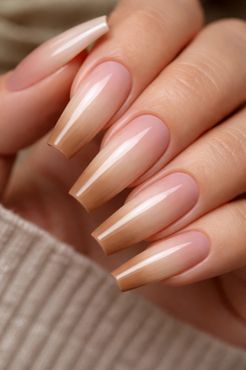 Coffin nails with warm latte ombré gradient from sheer to caramel