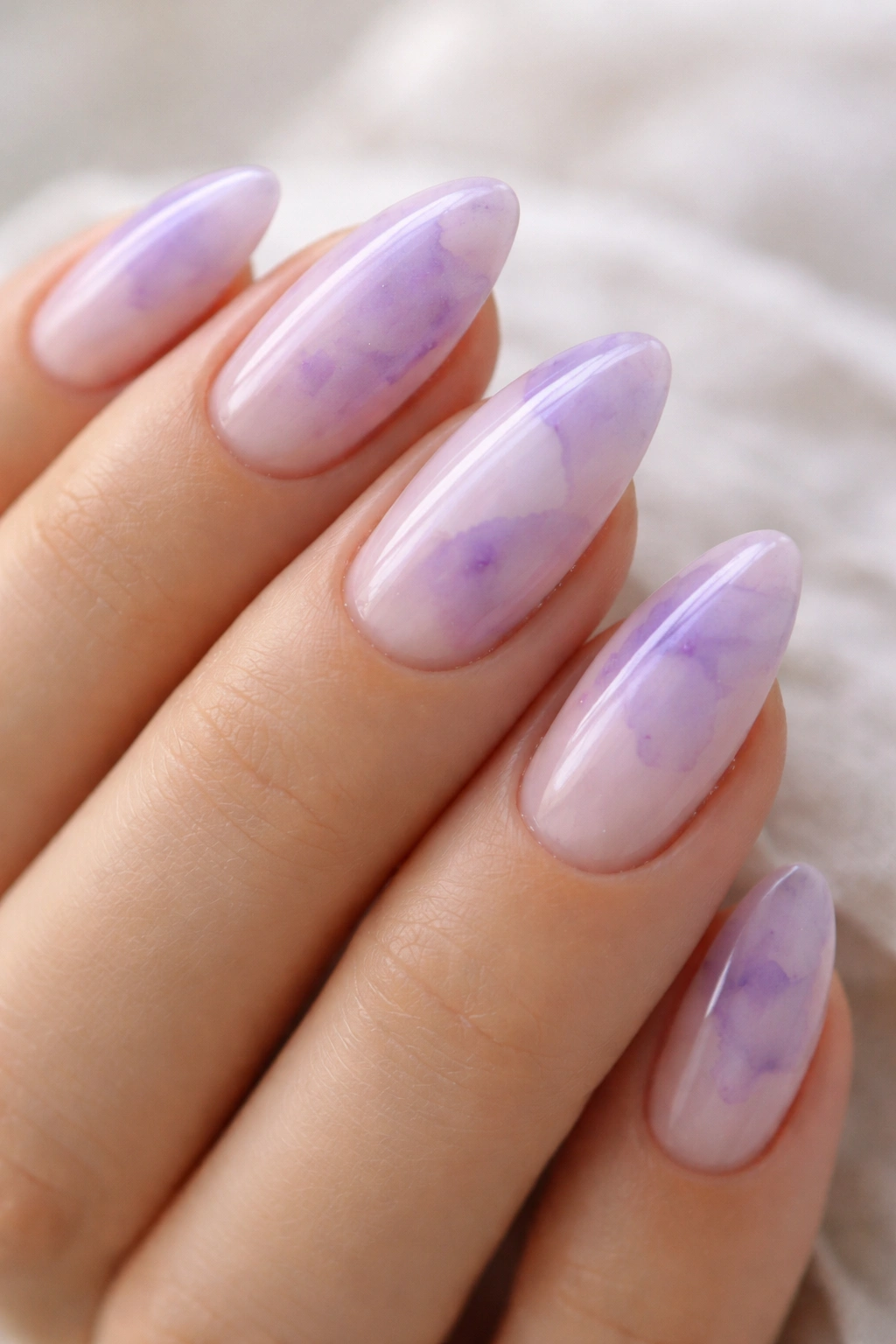 Almond nails with watercolor lilac washes on sheer base