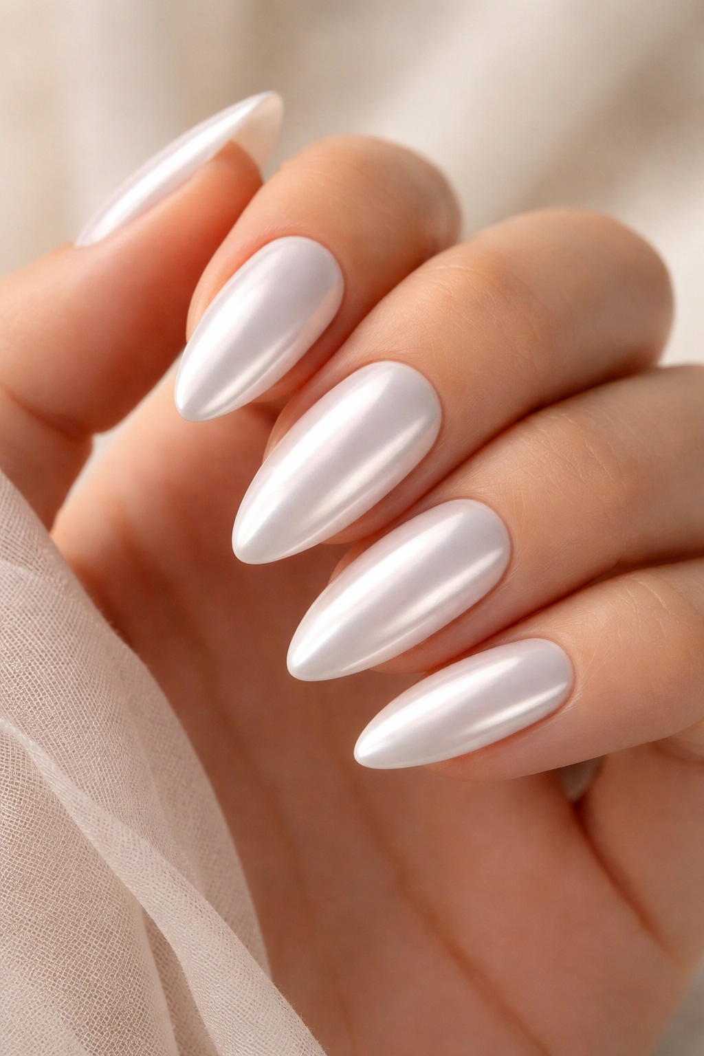 Almond nails with white chrome pearly reflective surface