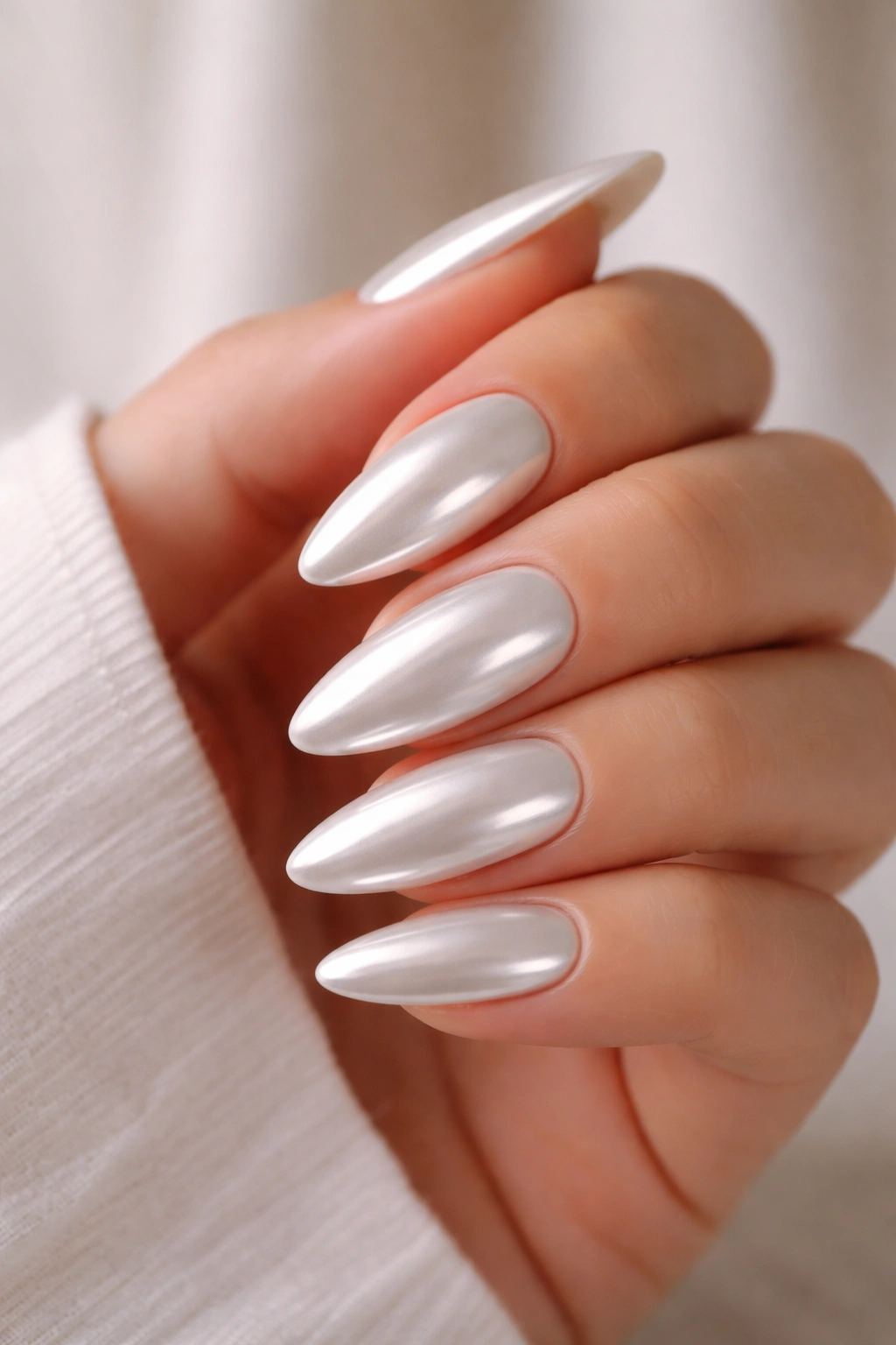 Almond nails with white chrome finish reflecting light