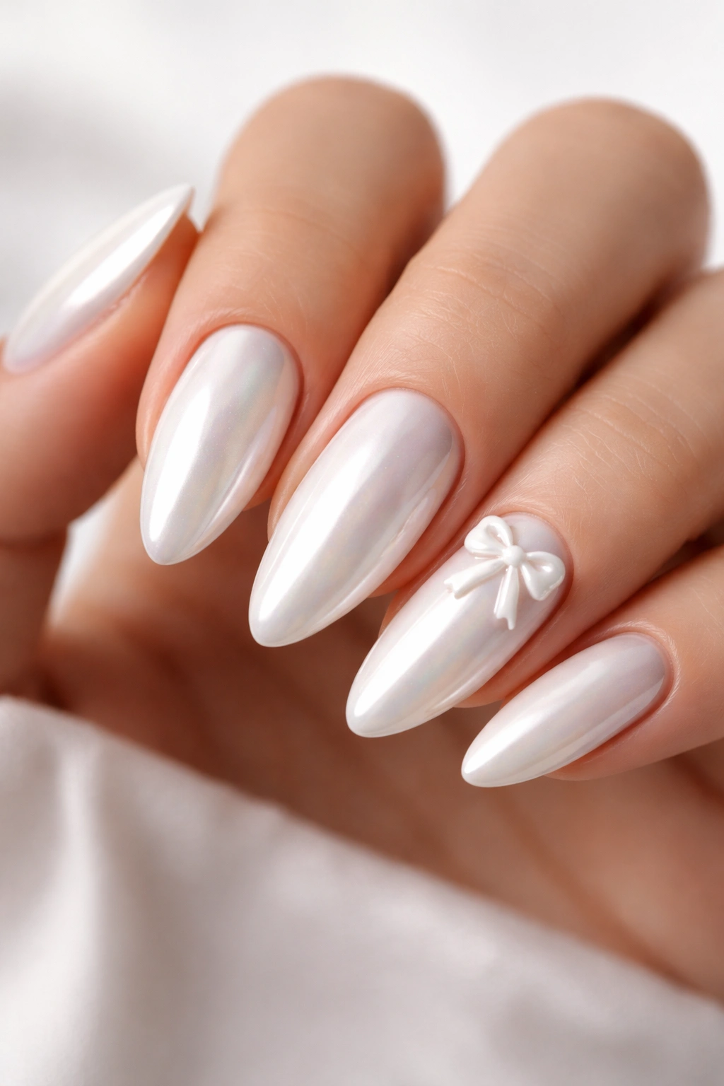 Almond nails with sculpted 3D bows on white chrome