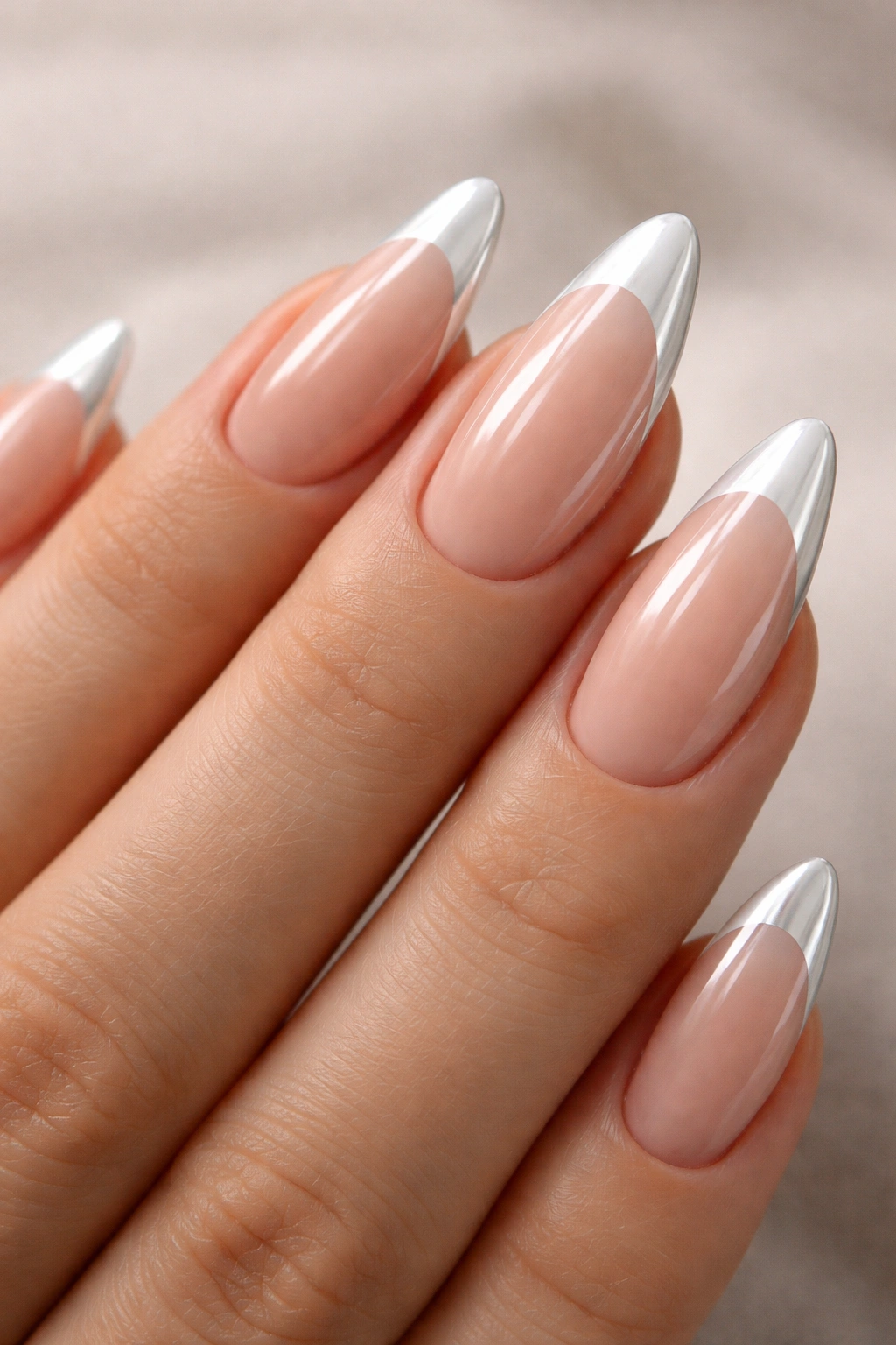 Almond nails with nude base and white chrome French tips