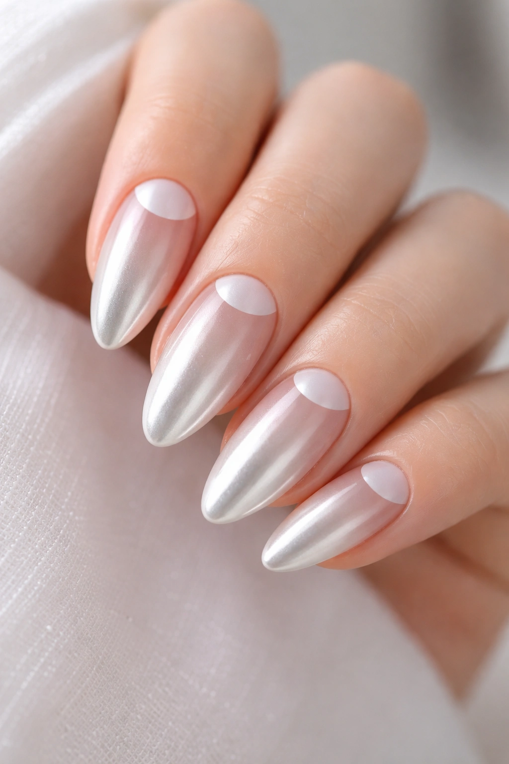 Close-up of White Chrome Half-Moon Negative Space on almond nails with a crisp base