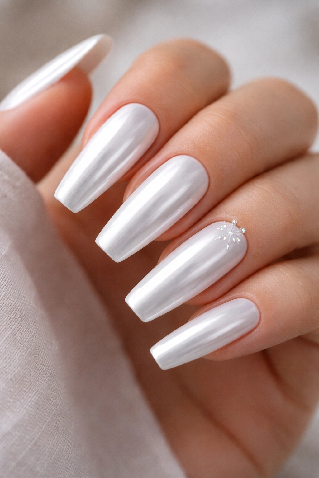 White chrome coffin nails with tiny starburst accents